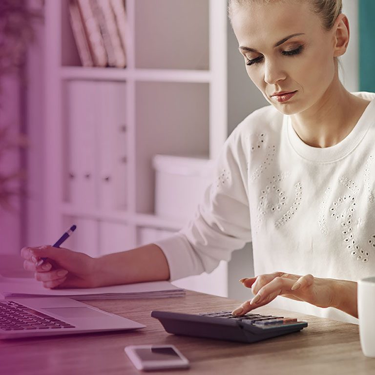 Concentrated woman budgeting at office