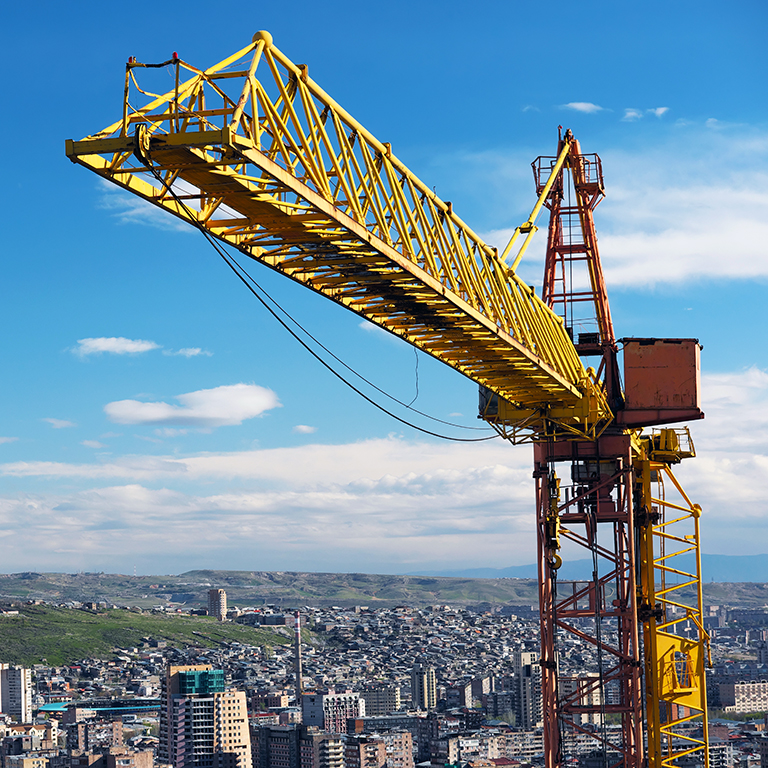 Construction crane tower against a blue sky