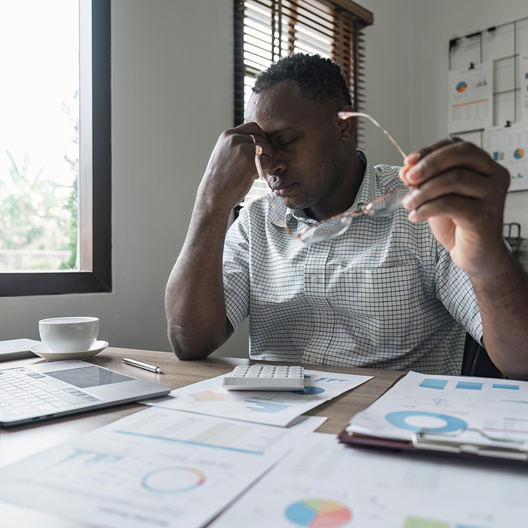 Stressed business man sitting at office workplace. Tired and overworked man. Exhausted men in stress working on laptop computer. accounting financial concept.