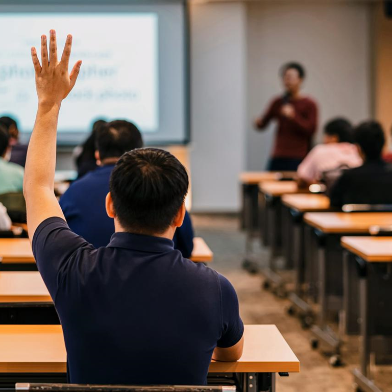 Student raising hand in classroom