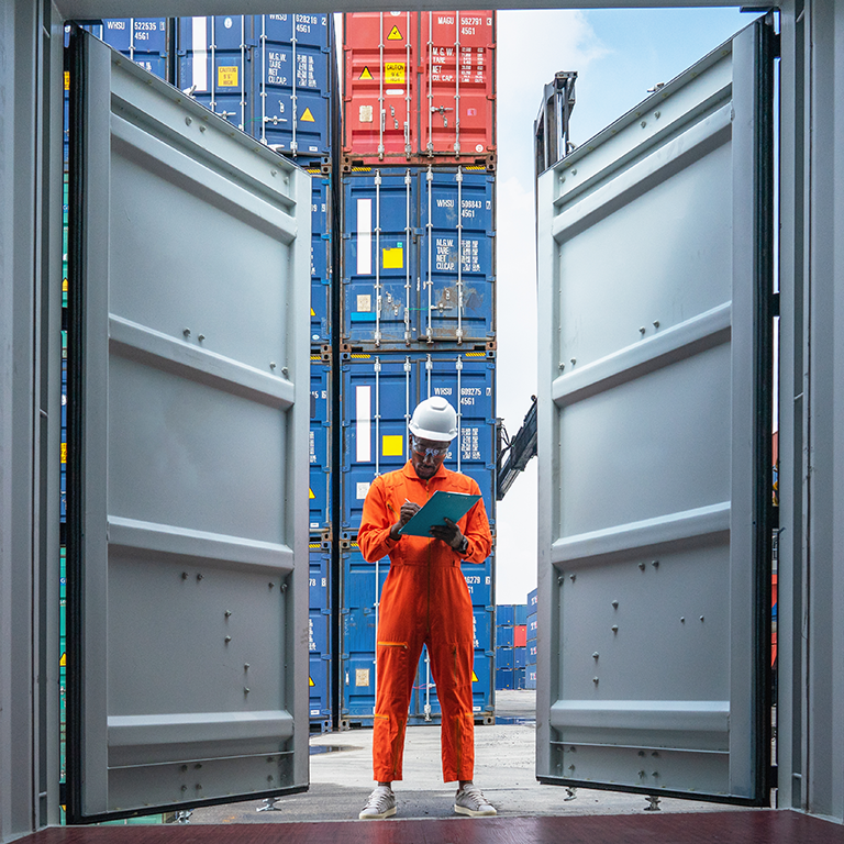 Worker checking on shipping container
