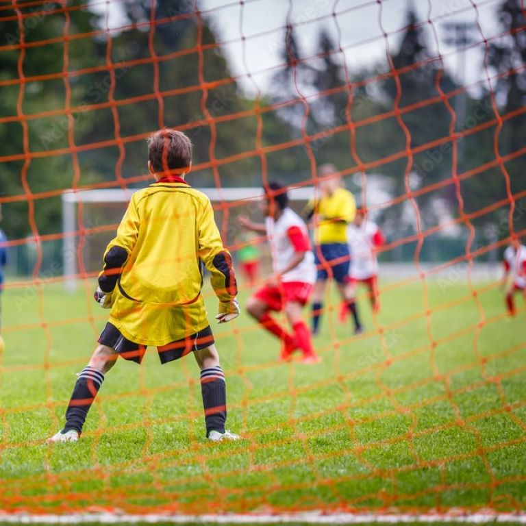 Young soccer goalie defending the net